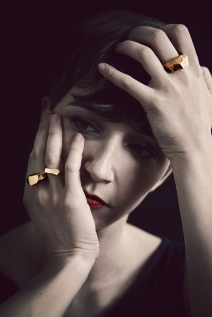 model wears Gold Asym Rings